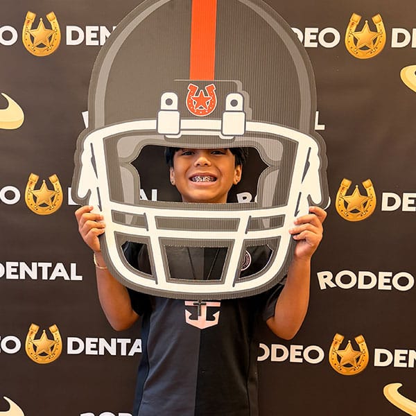 Teen showing off straight teeth after braces removal