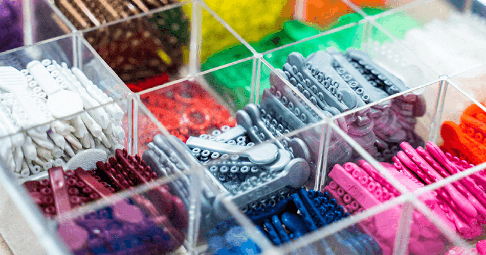 Teen with colorful braces bands during orthodontic visit